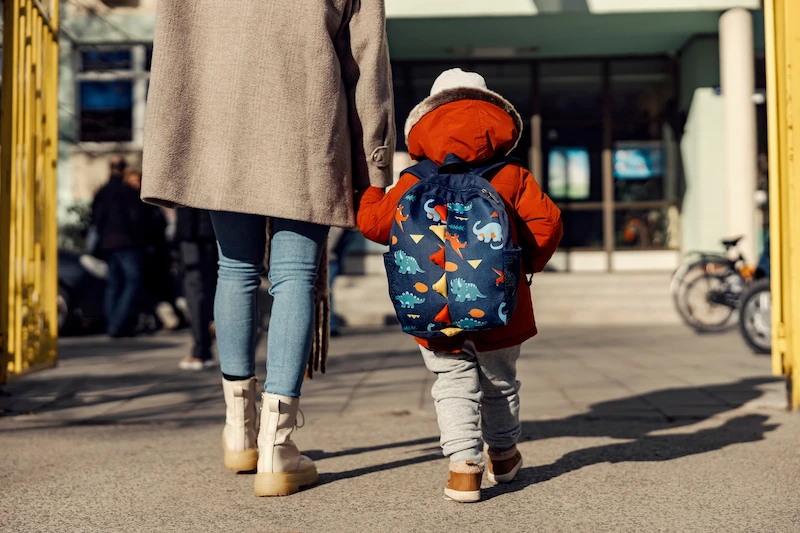 mae e filho de maos dadas entrando na escola